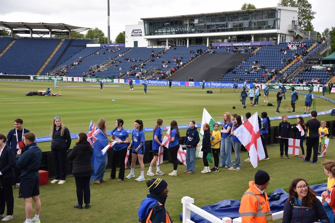 Flag bearers lined along the boundary at Sophia Gardens